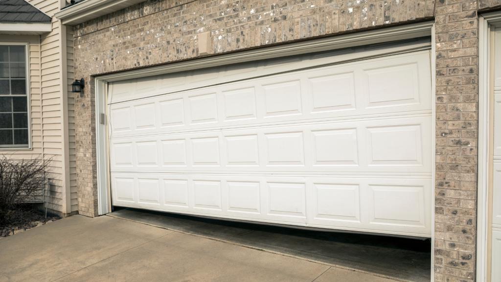 Garage door off track and uneven, a common reason your garage door won’t close.