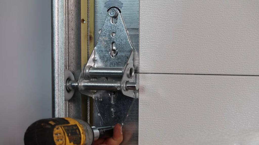 Tightening the hardware during garage door roller installation