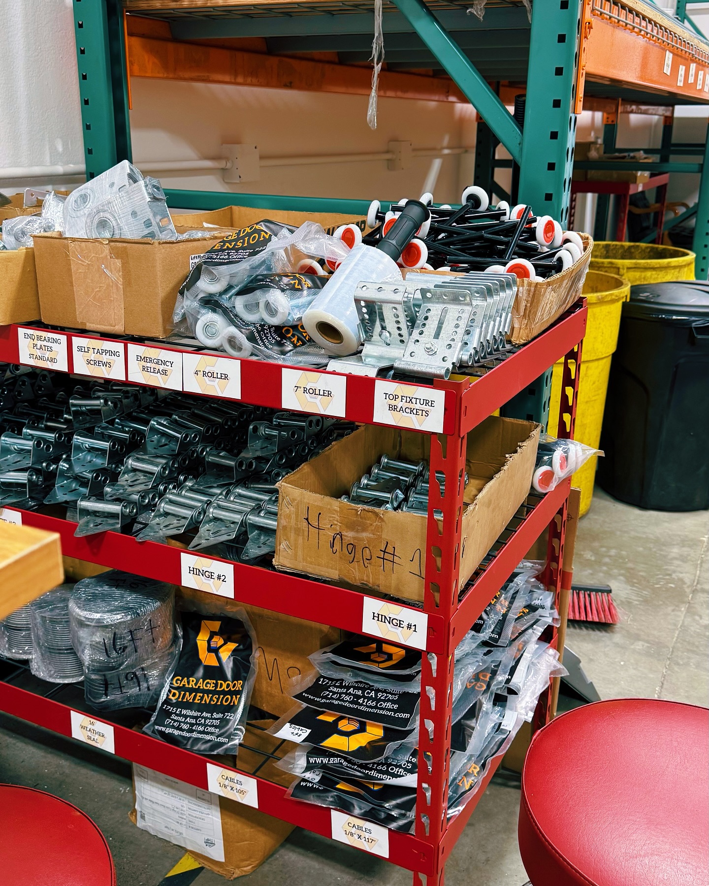 A shelf of garage door parts and supplies from Garage Door Dimension