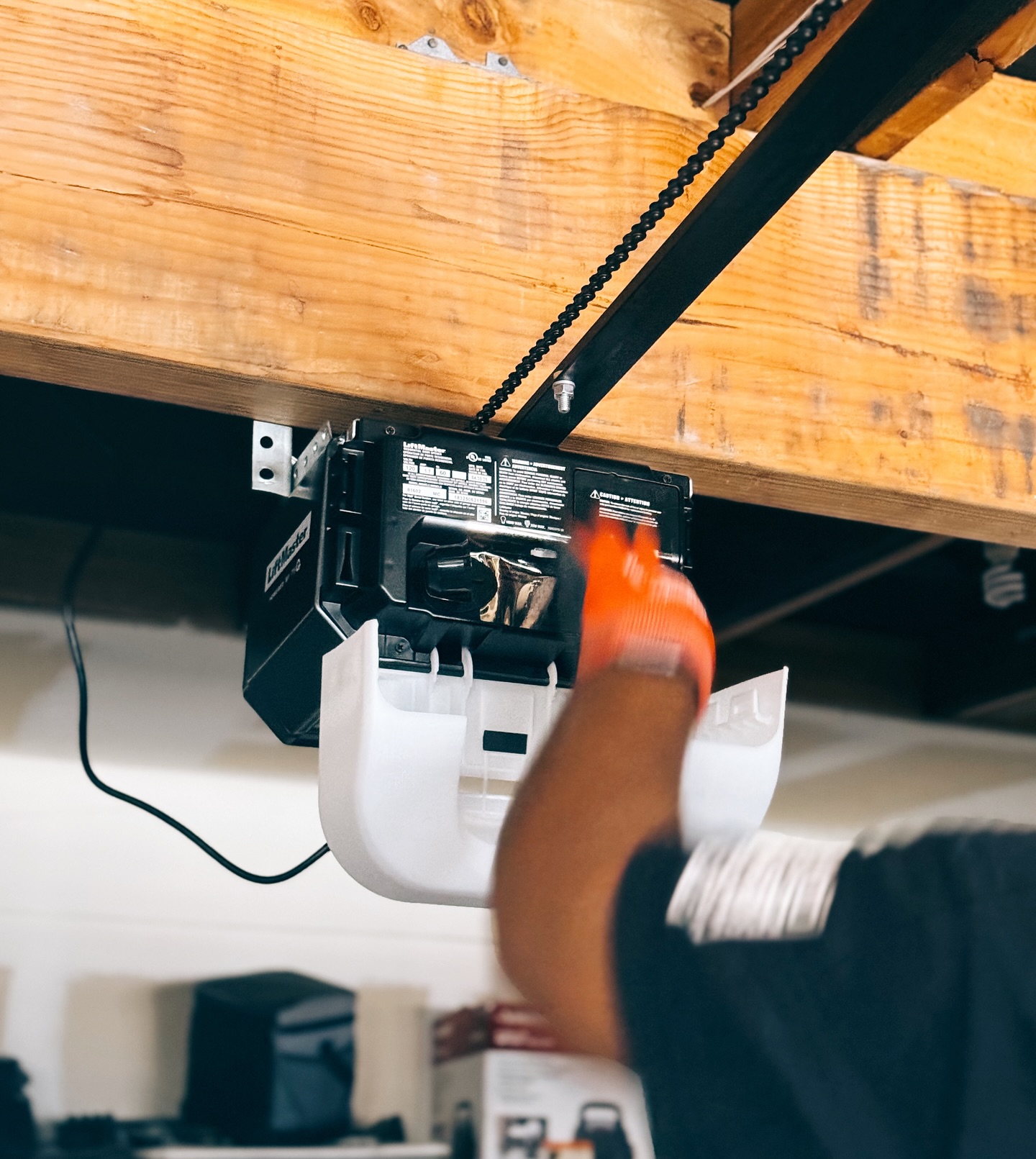 A certified technician performing garage door maintenance in Santa Ana