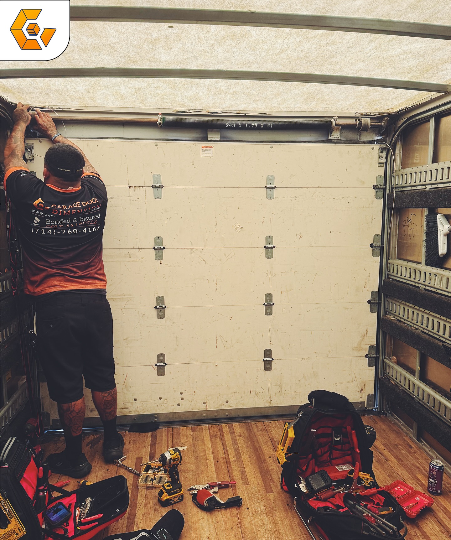 A certified technician repairing a garage door spring in Santa Ana