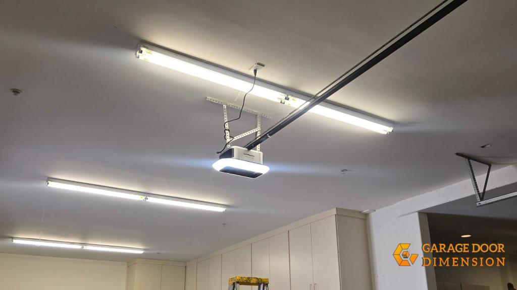 Technician installing a garage door opener in a residential garage in Santa Ana, CA